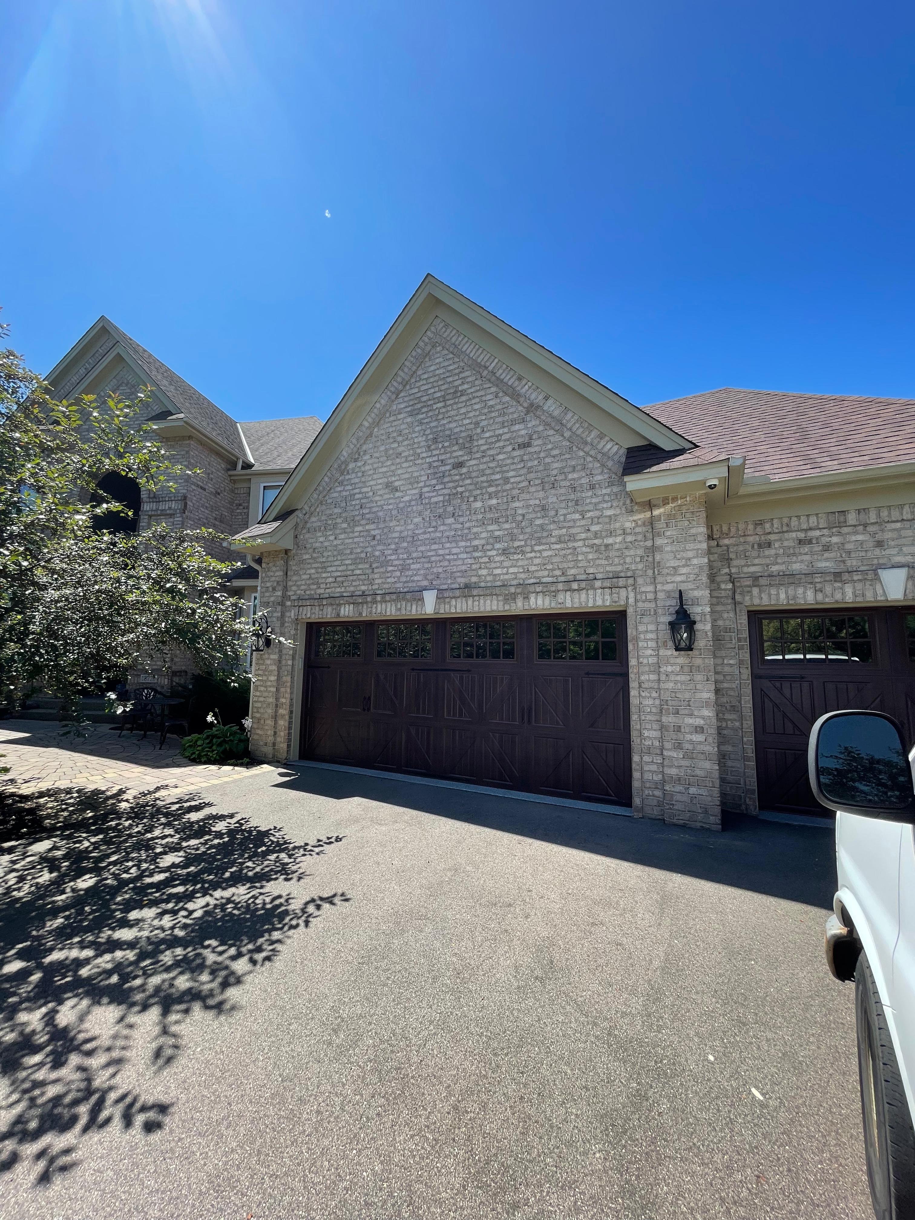 Brick home with brown garage doors